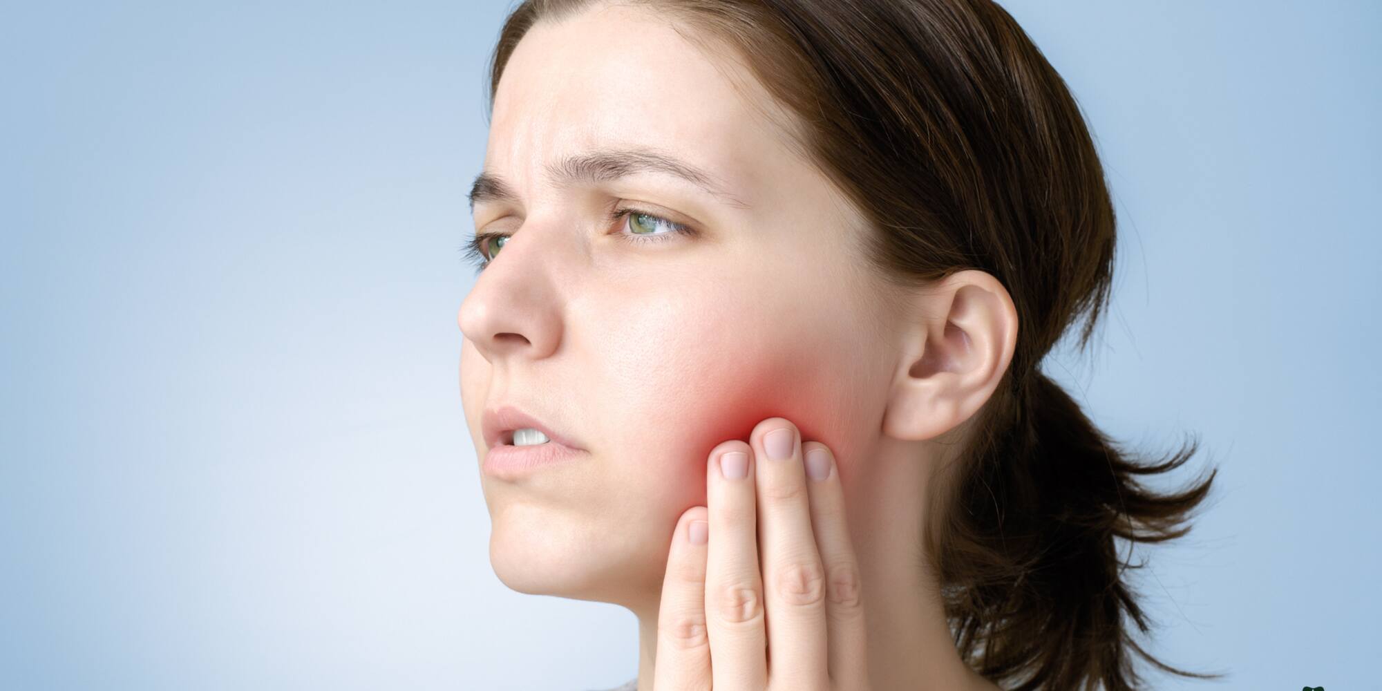 Emergency dental care at The Pines Dental Centre a woman with hand on cheek, indicating dental discomfort.